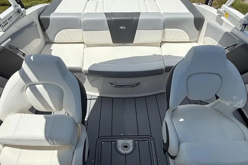 Slide: The Image of 2022 Chaparral 21 SSi OB boat interior with white seating and modern design. - 12