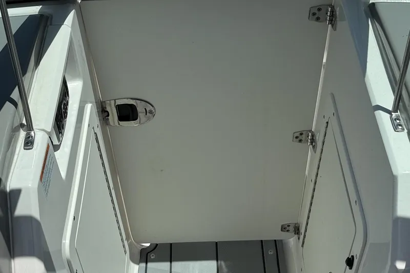 Slide: The Image of 2022 Chaparral 21 SSi OB boat interior with open storage compartment. - 14