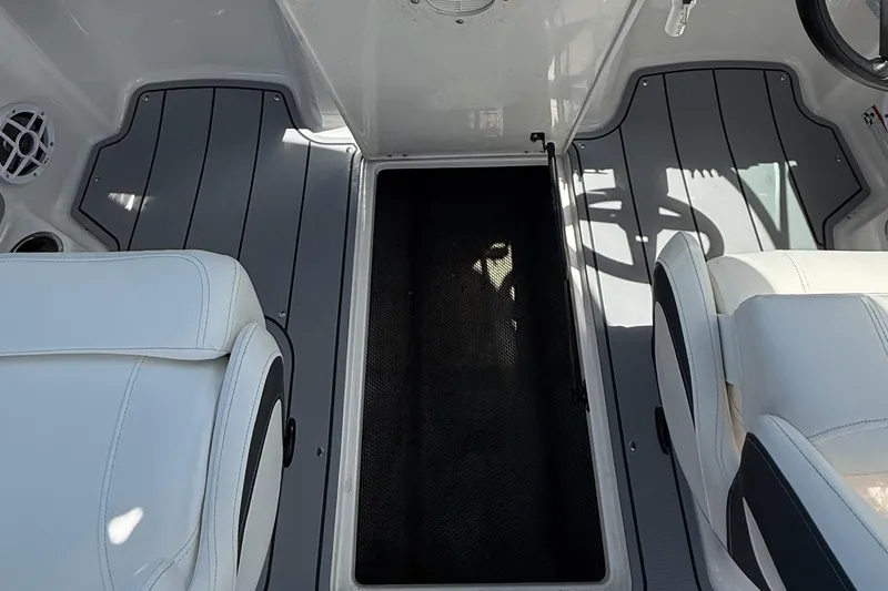 Slide: The Image of 2022 Chaparral 21 SSi OB boat interior with white seats and gray flooring. - 16