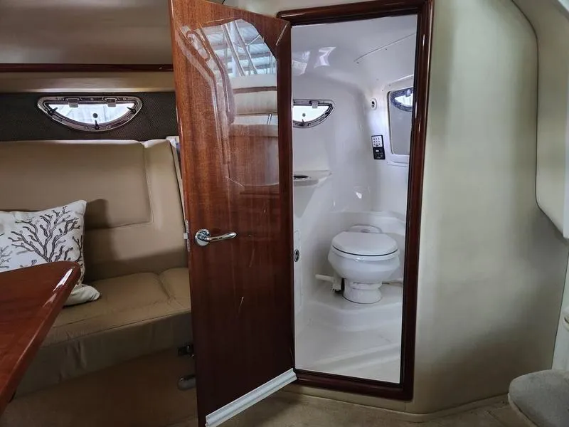 Slide: The Image of Interior of a 2006 Cobalt 323 boat showing a cabin and bathroom. - 2