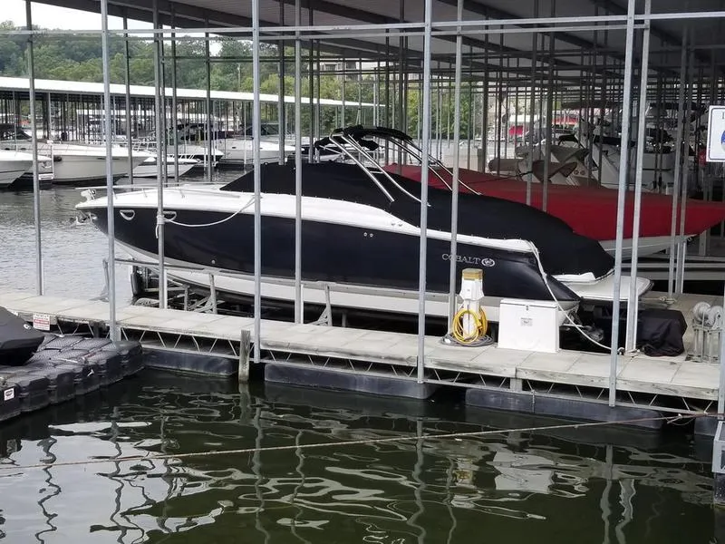 Slide: The Image of 2006 Cobalt 323 boat docked in a marina, covered and secured. - 7