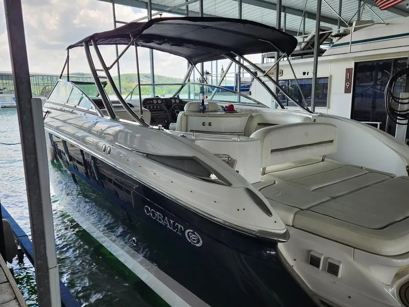 Slide: The Image of 2006 Cobalt 323 boat docked in marina, featuring sleek design and spacious seating. - 8