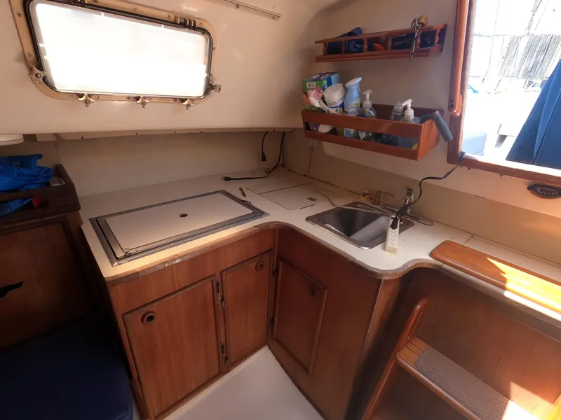 Slide: The Image of Interior of 1979 Hunter 30 sailboat kitchen with sink, storage, and window. - 10