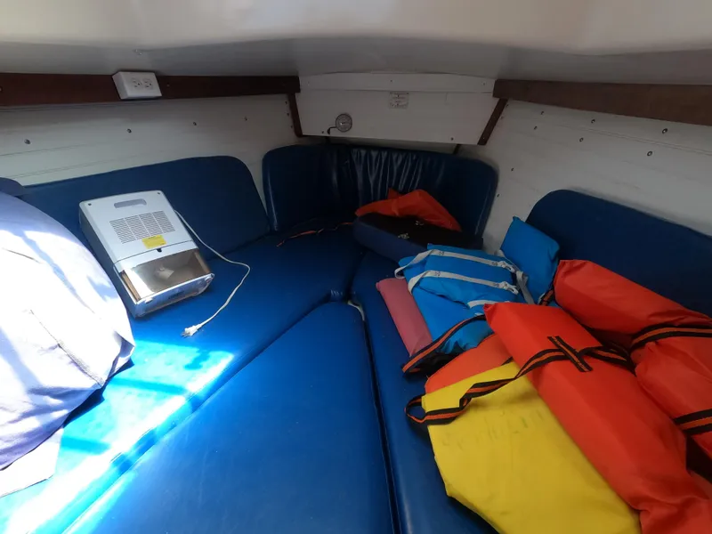 Slide: The Image of Interior of 1979 Hunter 30 sailboat with blue cushions and colorful life jackets. - 15