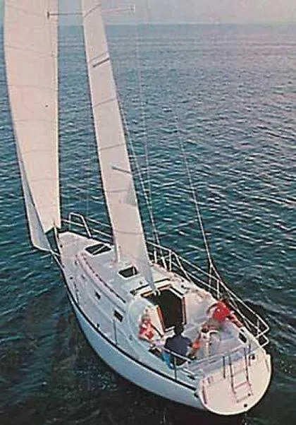 Slide: The Image of 1979 Hunter 30 sailboat cruising on open water. - 19