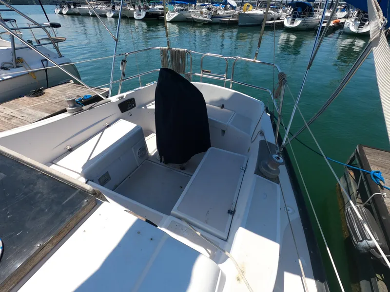 Slide: The Image of 1979 Hunter 30 sailboat cockpit at marina, featuring seating and storage compartments. - 4