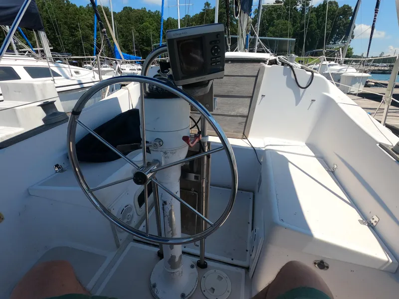 Slide: The Image of Cockpit of a 1979 Hunter 30 sailboat with steering wheel and navigation equipment. - 6