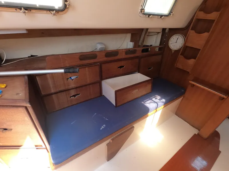 Slide: The Image of Interior of 1979 Hunter 30 sailboat with wooden drawers and blue cushion seating. - 8