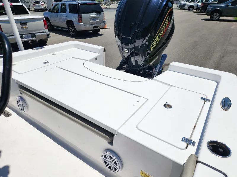 Slide: The Image of 2023 Sportsman Masters 227 Bay Boat with powerful outboard motor in parking lot. - 11