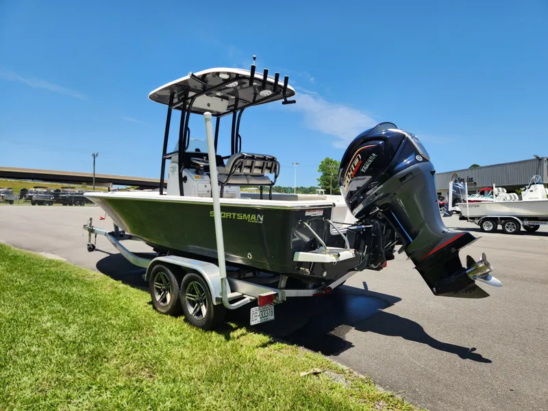 Slide: The Image of 2023 Sportsman Masters 227 Bay Boat on trailer, featuring powerful outboard motor. - 3