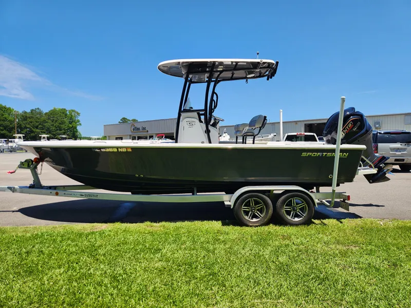 Slide: The Image of 2023 Sportsman Masters 227 Bay Boat on trailer, parked outdoors under clear blue sky. - 4