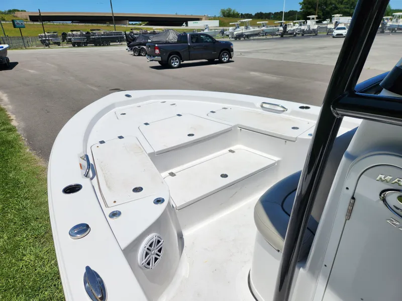 Slide: The Image of 2023 Sportsman Masters 227 Bay Boat interior with storage compartments, parked outdoors. - 6