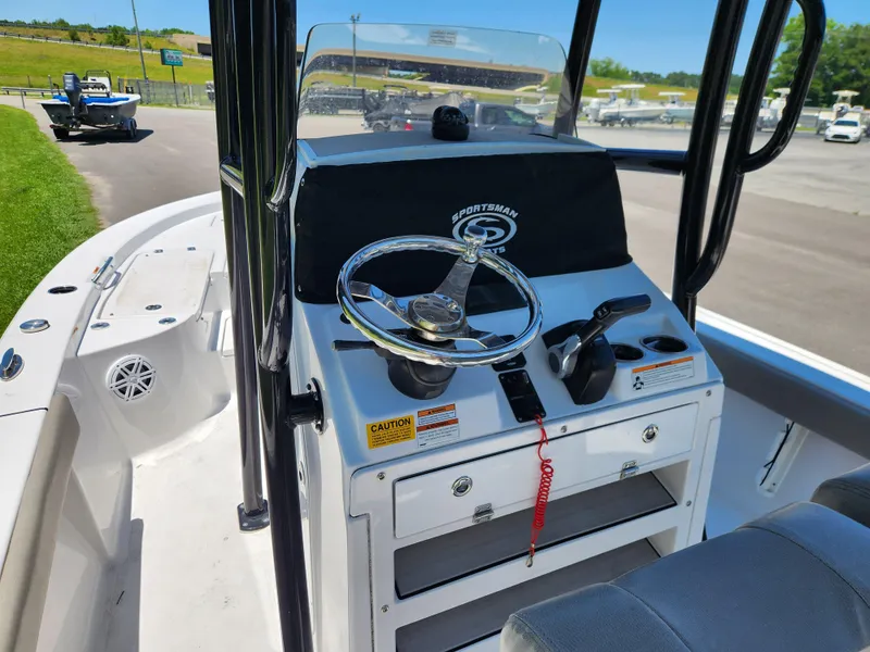 Slide: The Image of 2023 Sportsman Masters 227 Bay Boat dashboard with steering wheel and controls. - 7