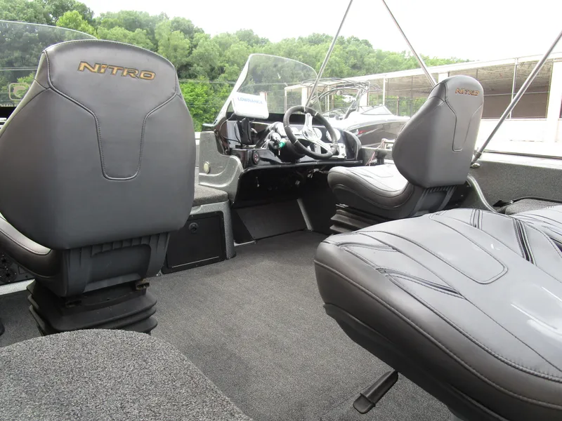 Slide: The Image of Interior of 2021 Nitro ZV21 boat with black leather seats and steering console. - 15