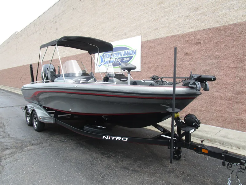 Slide: The Image of 2021 Nitro ZV21 boat on trailer, parked outside Grand Pointe Marina. - 3