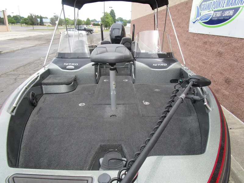 Slide: The Image of 2021 Nitro ZV21 fishing boat with spacious deck and seating, parked at Grand Pointe Marina. - 4