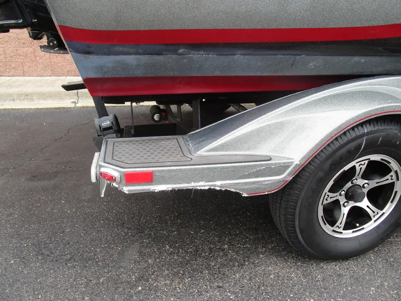 Slide: The Image of 2021 Nitro ZV21 boat trailer with silver fender and black wheel on asphalt. - 8