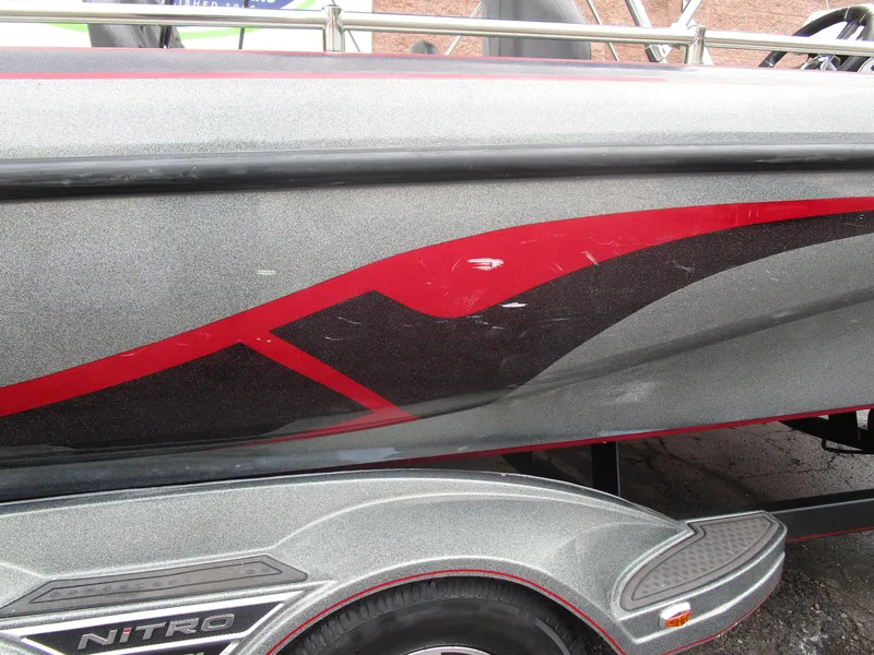 Slide: The Image of 2021 Nitro ZV21 boat with sleek red and black graphics on a metallic gray body. - 9