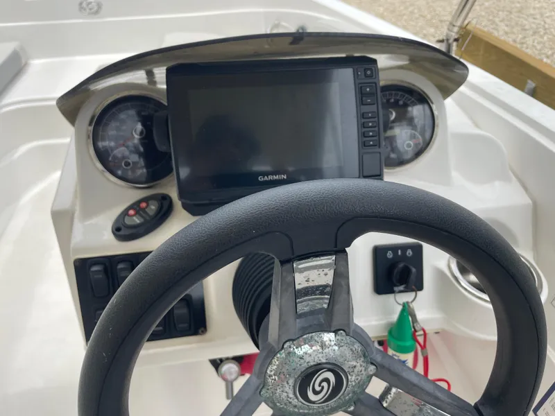 Slide: The Image of 2021 Hurricane SunDeck Sport 185 OB dashboard with Garmin display and steering wheel. - 10