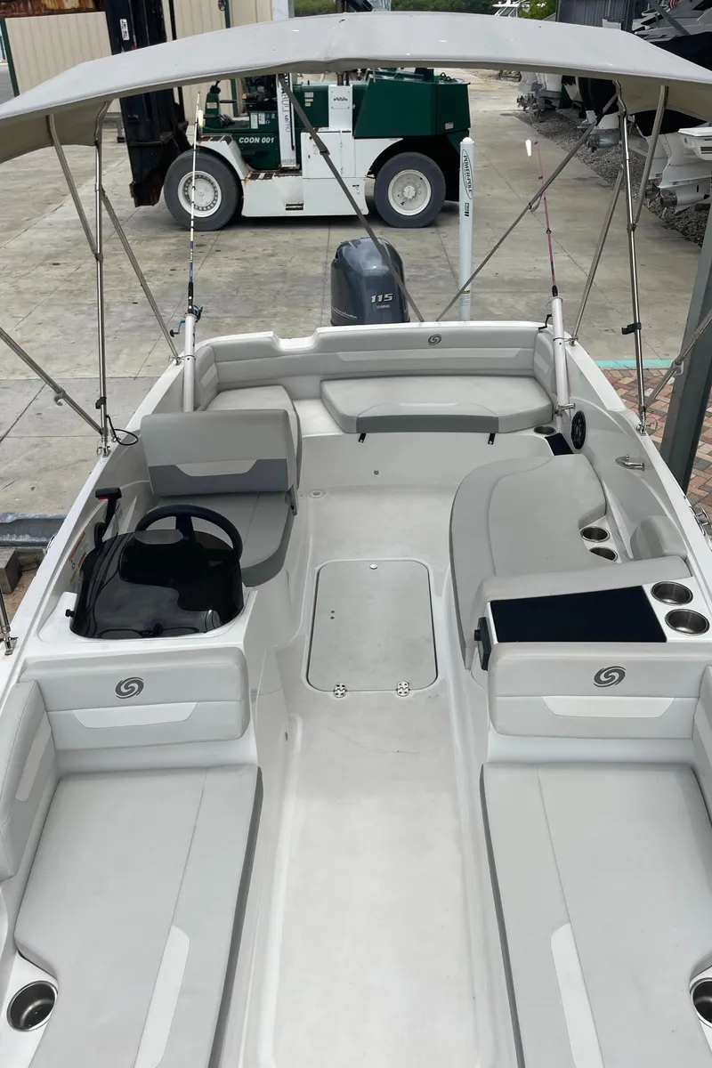 Slide: The Image of 2021 Hurricane SunDeck Sport 185 OB boat interior with seating and steering console. - 13