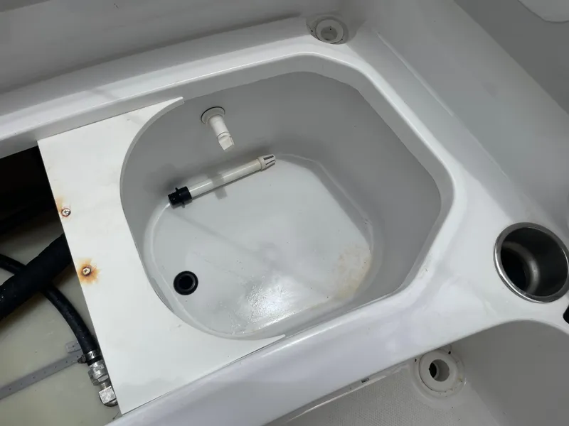 Slide: The Image of 2021 Hurricane SunDeck Sport 185 OB boat compartment with drain and cup holder. - 16