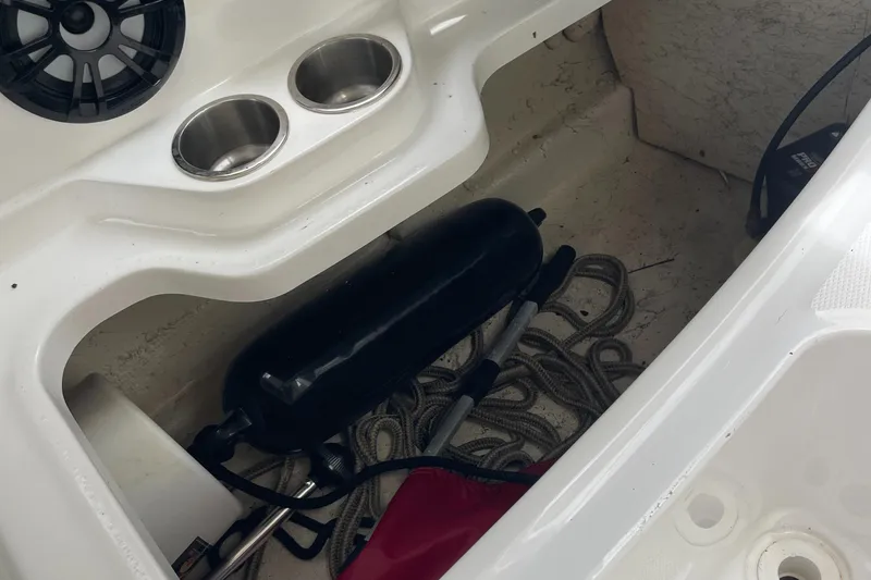 Slide: The Image of Interior of 2021 Hurricane SunDeck Sport 185 OB boat with storage area and accessories. - 17