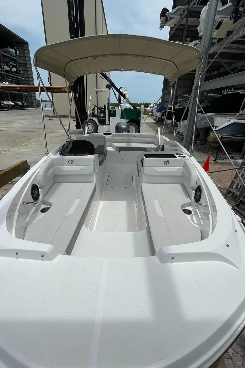 Slide: The Image of 2021 Hurricane SunDeck Sport 185 OB boat with canopy, docked in a marina. - 20