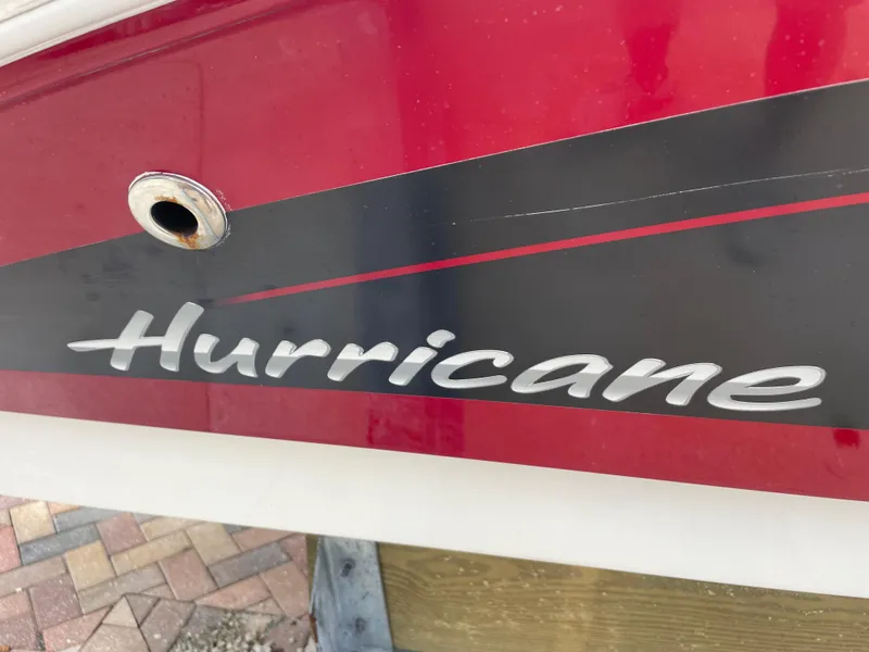 Slide: The Image of Red and black 2021 Hurricane SunDeck Sport 185 OB boat with logo. - 27