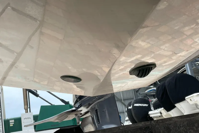 Slide: The Image of 2021 Hurricane SunDeck Sport 185 OB boat hull and propeller detail in a storage facility. - 28