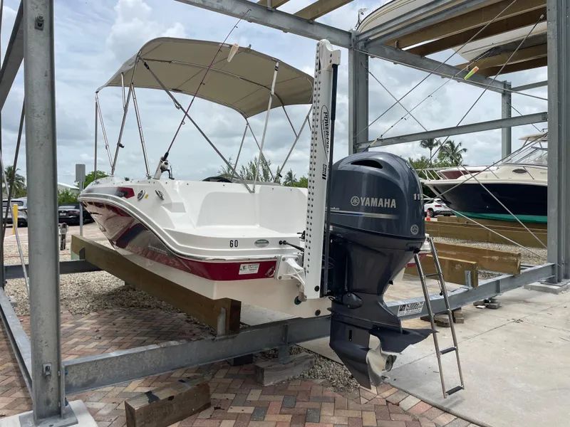 Slide: The Image of 2021 Hurricane SunDeck Sport 185 OB boat with Yamaha outboard motor on a rack. - 37