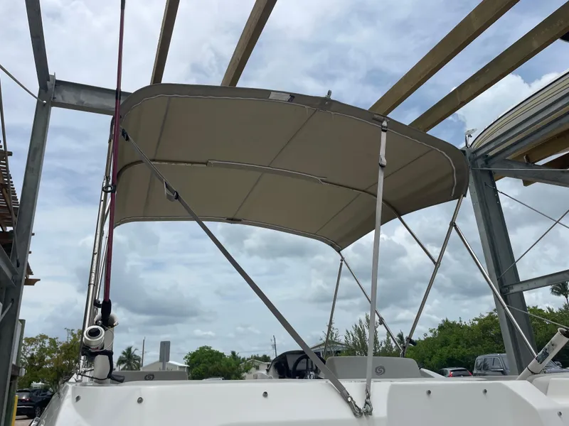 Slide: The Image of 2021 Hurricane SunDeck Sport 185 OB boat with canopy under cloudy sky. - 7