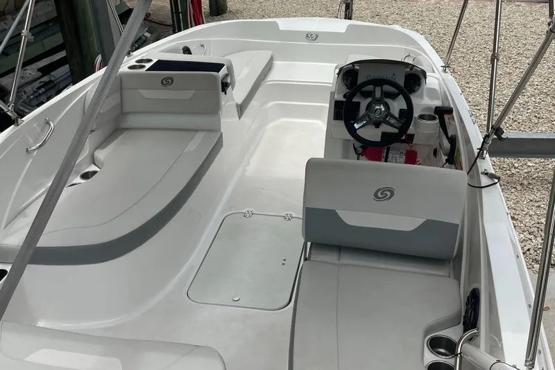 Slide: The Image of 2021 Hurricane SunDeck Sport 185 OB boat interior with seating and steering console. - 9