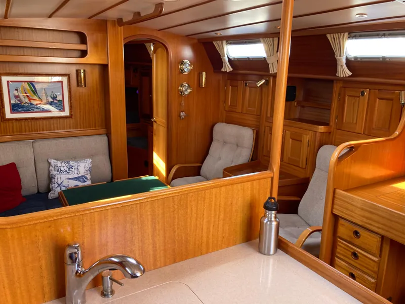 Slide: The Image of Interior of 2001 Malo 43 yacht with wooden finish and cozy seating area. - 10