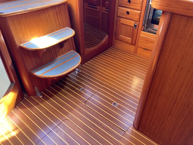 Slide: The Image of Wooden interior of a 2001 Malo 43 yacht, featuring steps and cabinetry. - 11
