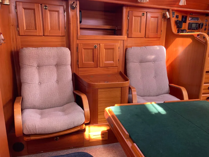 Slide: The Image of Interior of a 2001 Malo 43 yacht with wooden cabinetry and cushioned seating. - 13