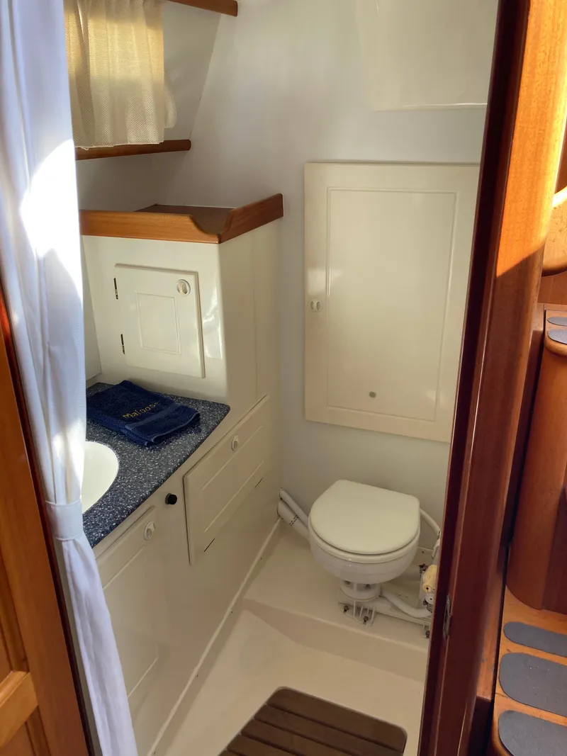 Slide: The Image of Compact bathroom in a 2001 Malo 43 yacht, featuring a toilet and sink. - 27