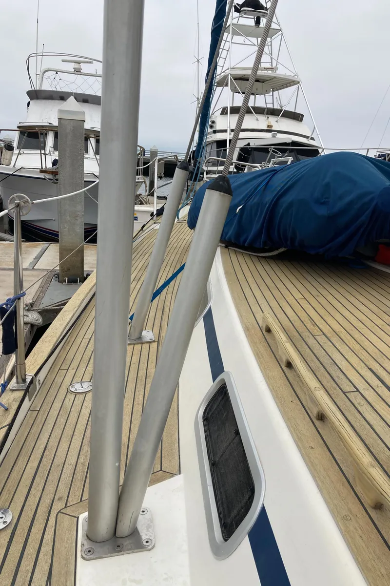 Slide: The Image of 2001 Malo 43 sailboat deck with wooden finish and marina view. - 32