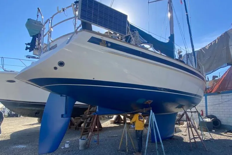 Slide: The Image of Sailboat Malo 43, 2001 model, in dry dock with solar panels and blue hull. - 40