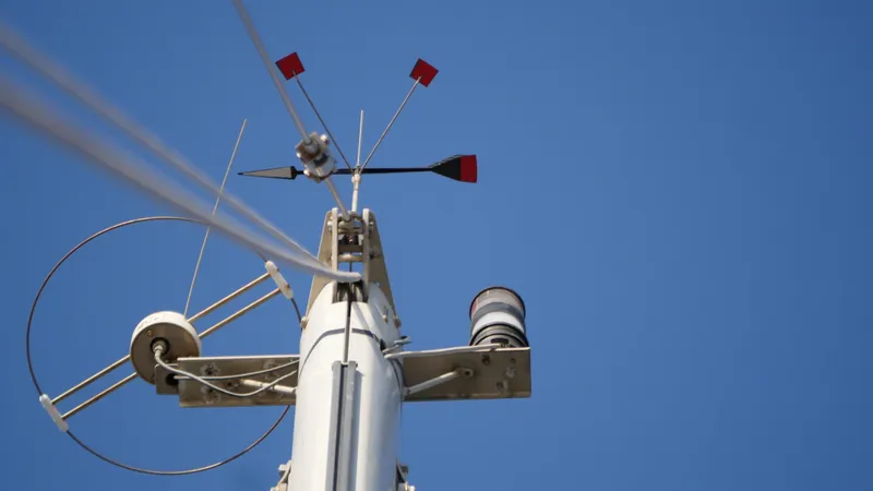 Slide: The Image of Sailboat mast with wind vane and instruments against clear blue sky, Malo 43, 2001. - 45