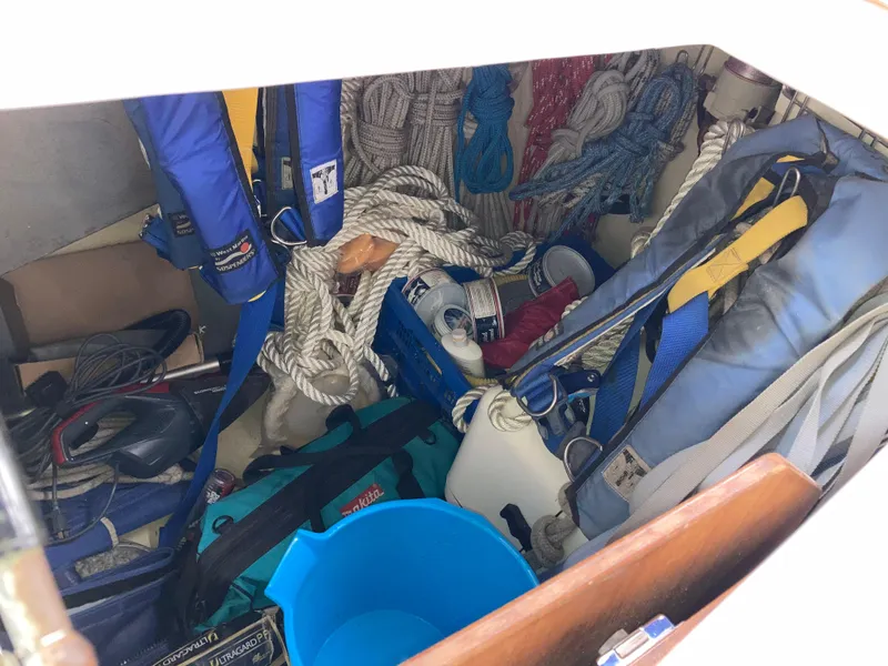 Slide: The Image of Storage compartment filled with sailing gear and ropes on a 2001 Malo 43 boat. - 48