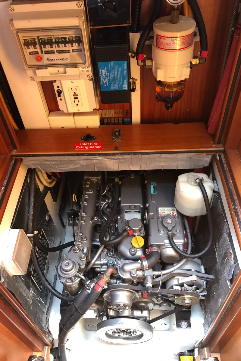 Slide: The Image of Engine compartment of a 2001 Malo 43 sailboat, showcasing mechanical components and electrical systems. - 50