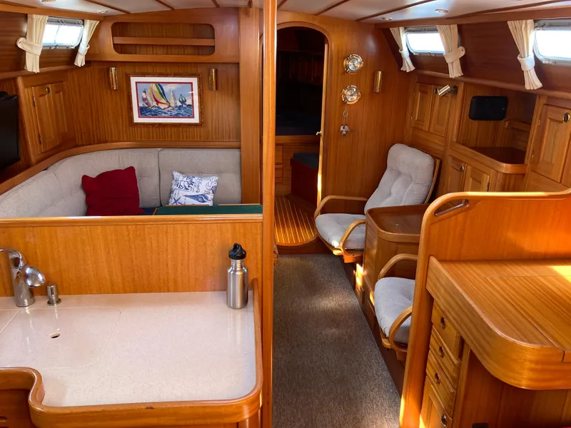 Slide: The Image of Interior of 2001 Malo 43 yacht with wooden furnishings and cozy seating area. - 6