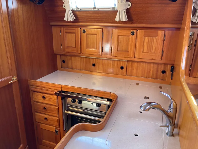Slide: The Image of Wooden yacht kitchen interior with cabinets, stove, and sink; Malo 43, 2001 model. - 7