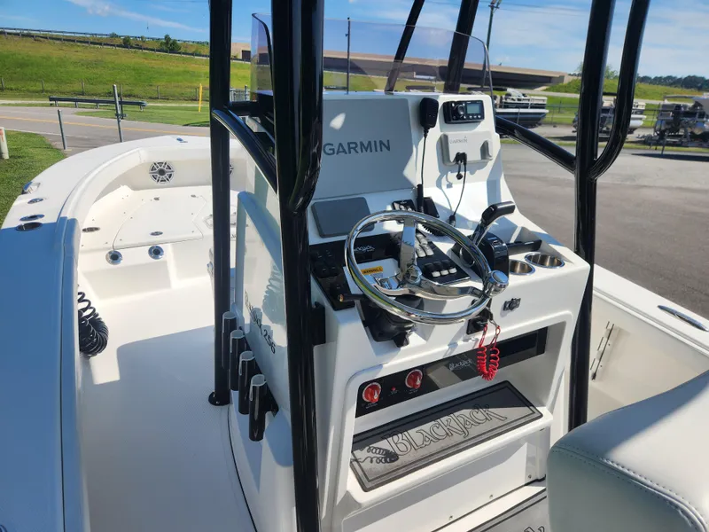 Slide: The Image of 2021 BlackJack 256 Coastal boat interior with Garmin navigation system and steering wheel. - 12