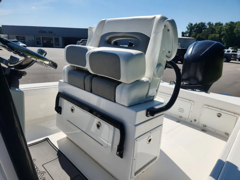 Slide: The Image of 2021 BlackJack 256 Coastal boat seat with storage, steering wheel, and outboard motor. - 14