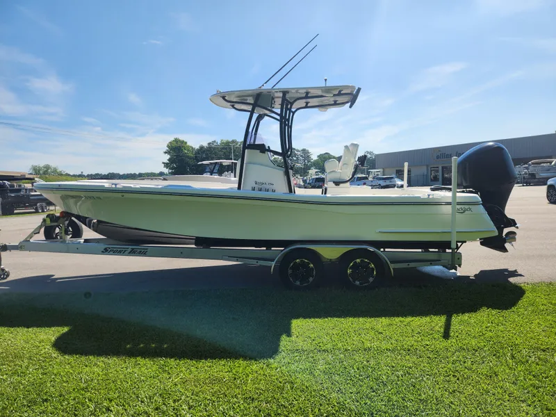 Slide: The Image of 2021 BlackJack 256 Coastal boat on trailer, parked outdoors under clear sky. - 6