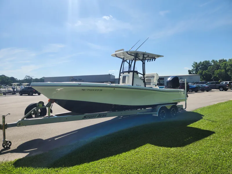 Slide: The Image of 2021 BlackJack 256 Coastal boat on trailer under clear blue sky. - 7