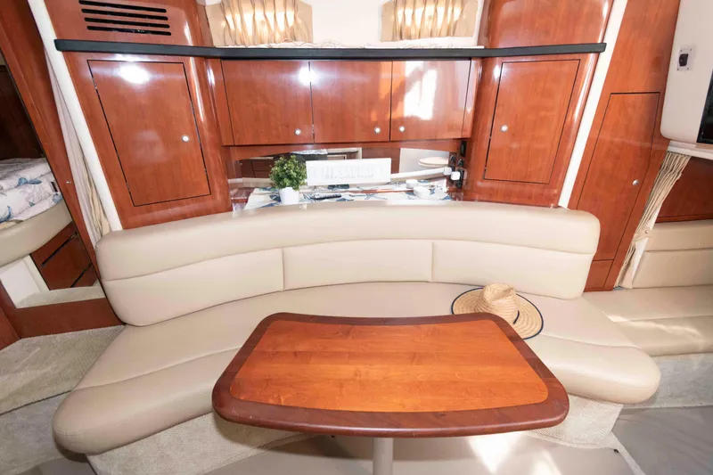Slide: The Image of Luxurious interior of 2007 Sea Ray 340 Sundancer with wooden cabinetry and beige seating. - 15