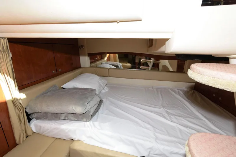 Slide: The Image of 2007 Sea Ray 340 Sundancer cabin interior with bed and pillows. - 17