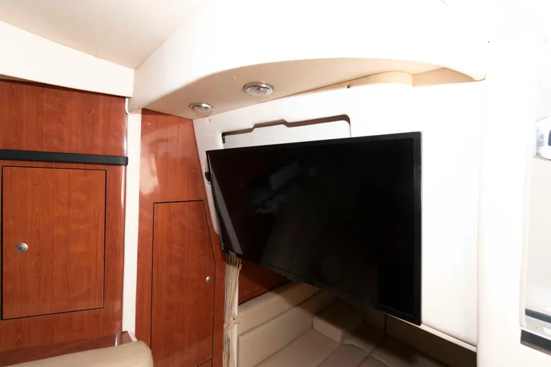 Slide: The Image of Interior of 2007 Sea Ray 340 Sundancer with mounted flat-screen TV and wooden cabinetry. - 18